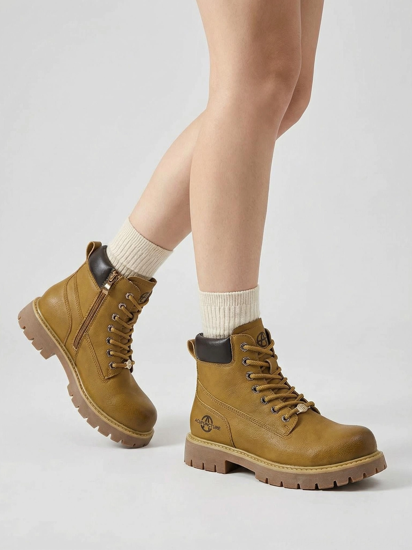 Side view of wheat yellow zip-front work ankle boots with lace-up detailing and rugged lug outsole