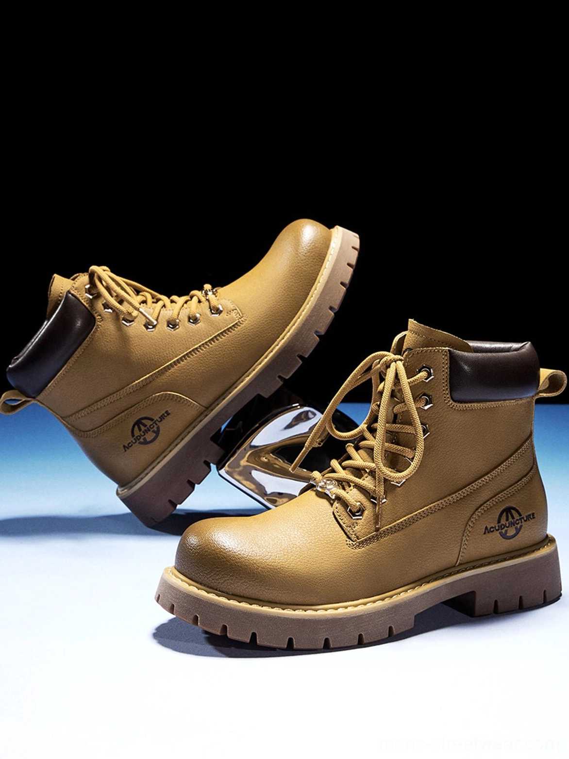 Pair of wheat yellow streetwear work boots shown from the side with branded-style outer detailing and lug soles