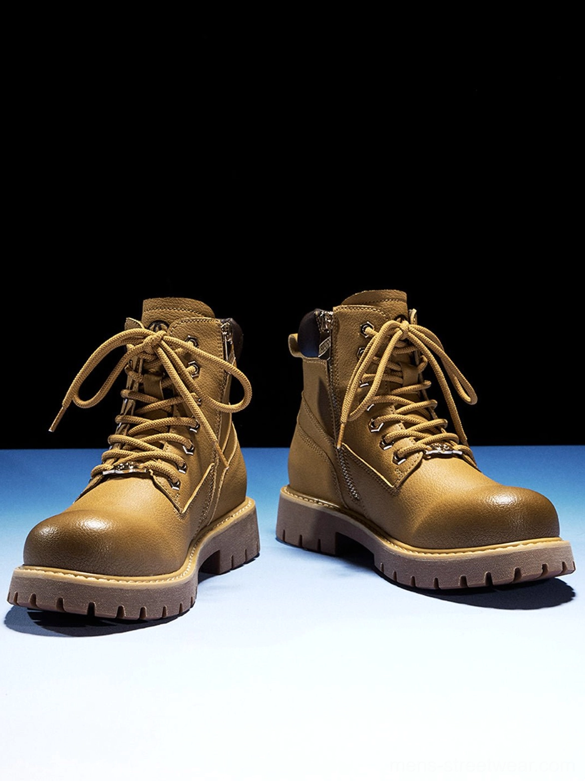Front three-quarter view of wheat yellow zip-front ankle boots with rounded toes and heavy utility soles