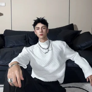 White 3D grid textured mock neck long sleeve streetwear top front view styled with black trousers and layered silver jewelry