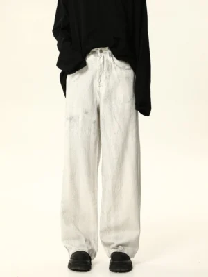 Front view of white acid wash wide leg baggy jeans styled with a black long sleeve top and chunky sneakers for Korean streetwear