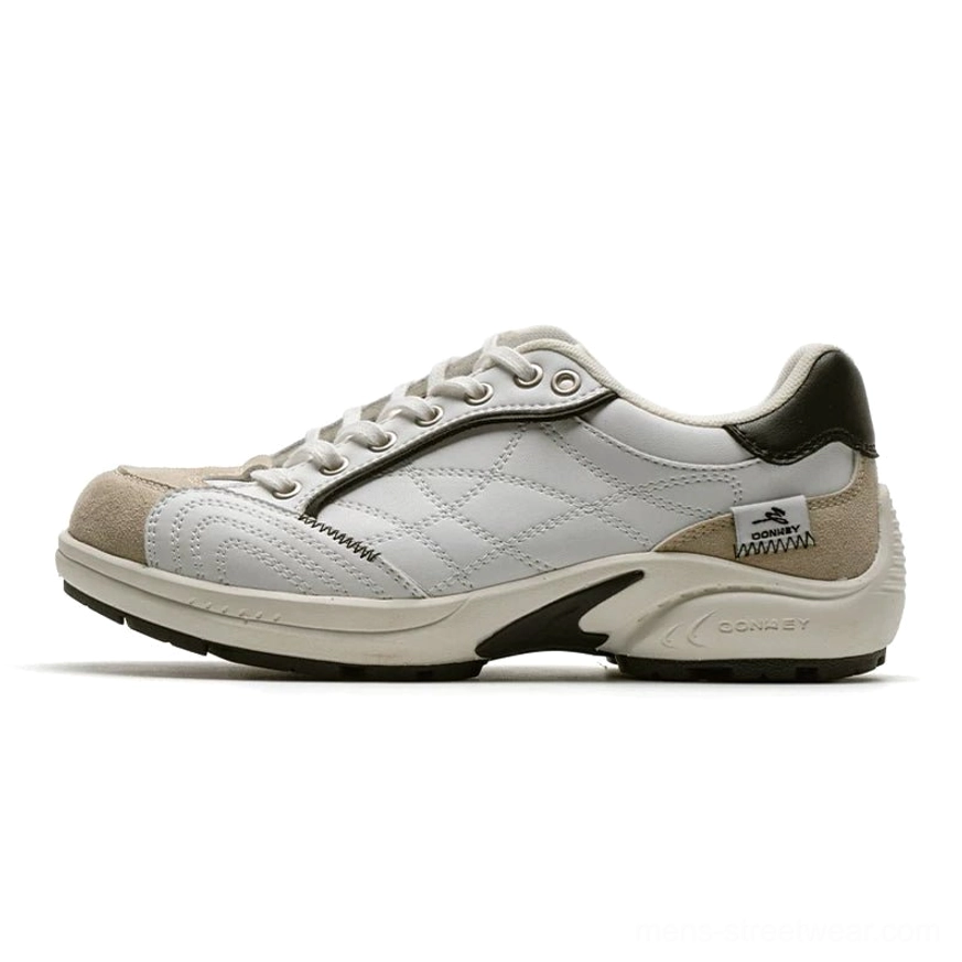 Two-tone white and beige retro runner sneakers with crisscross stitched panels, dark green heel tab, and off-white streetwear outsole