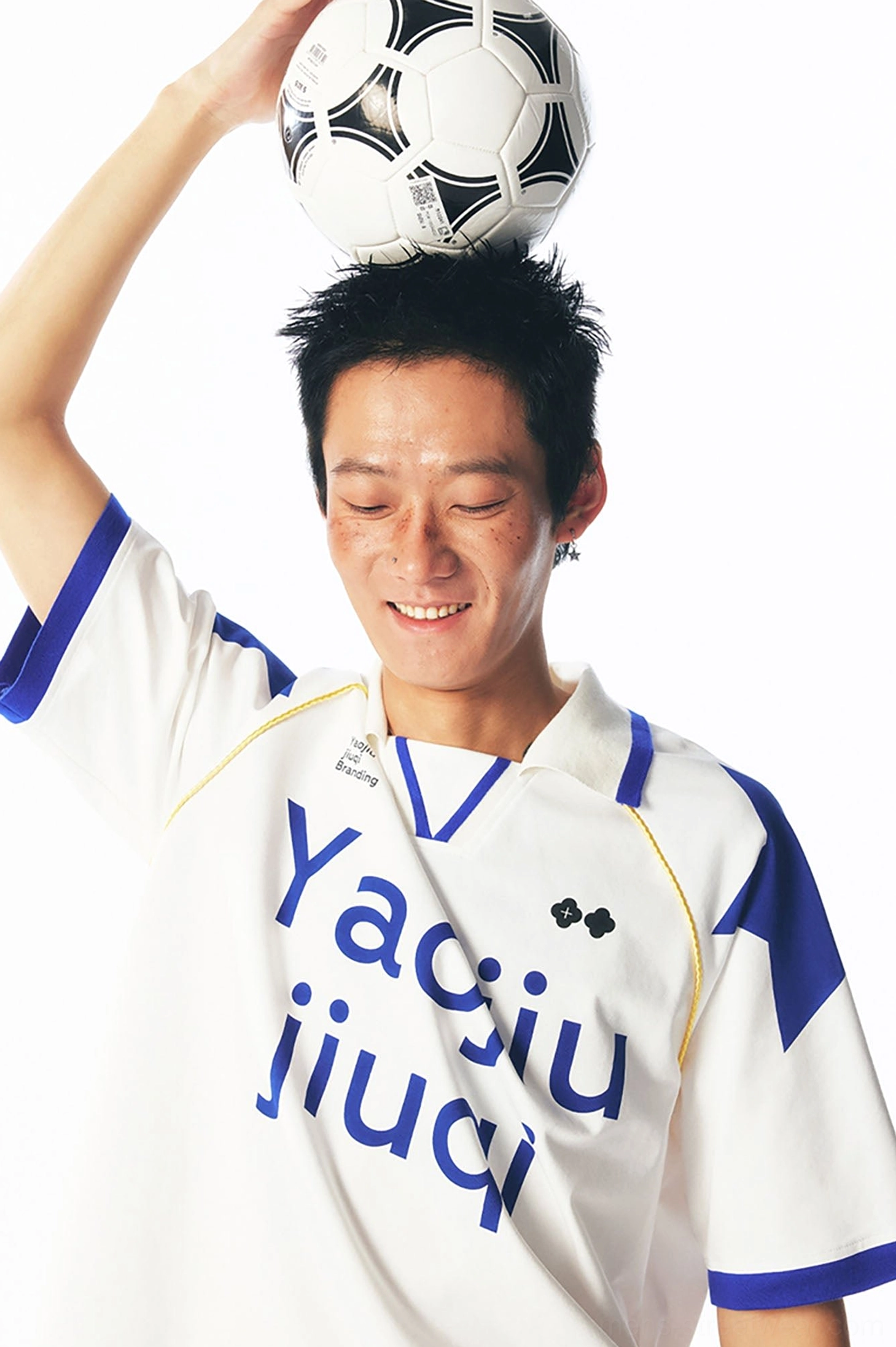 Close-up of a white and blue retro V-neck football jersey with yellow collar trim, blue shoulder panels, and Yaojiu jiuqi front print