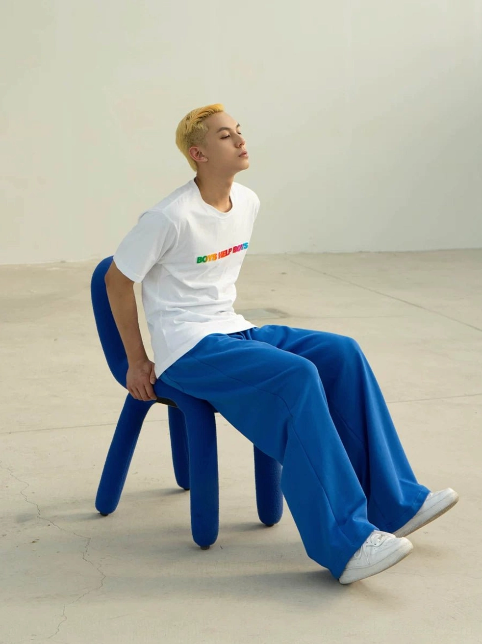 White Boys Help Boys rainbow graphic T-shirt with relaxed crewneck fit styled with blue wide-leg pants and white sneakers