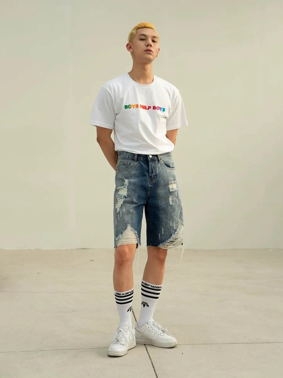 White Boys Help Boys rainbow graphic T-shirt styled with ripped denim shorts striped socks and white sneakers