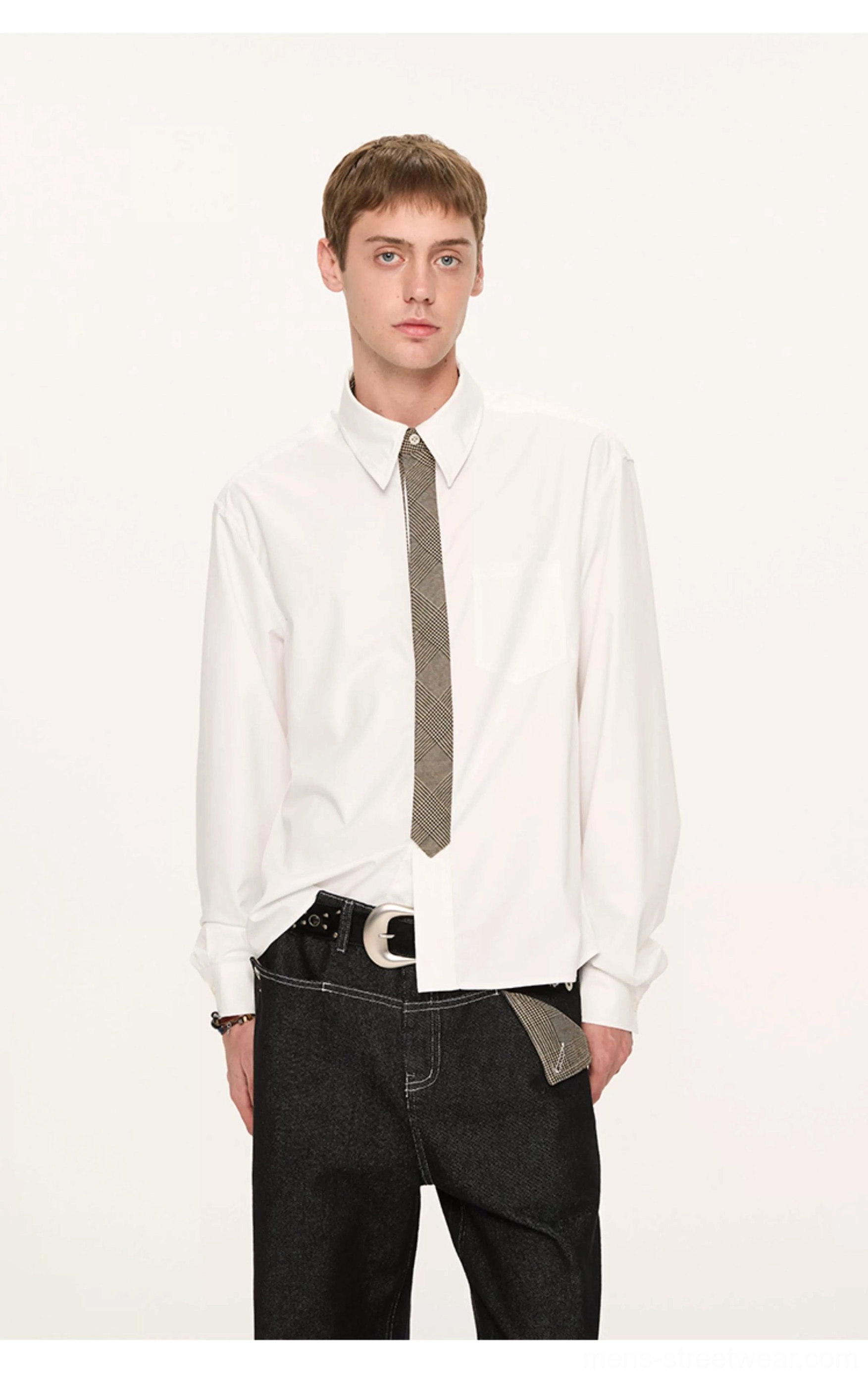 White long-sleeve button-down shirt with solid grey tie, black jeans, and decorative pocket square