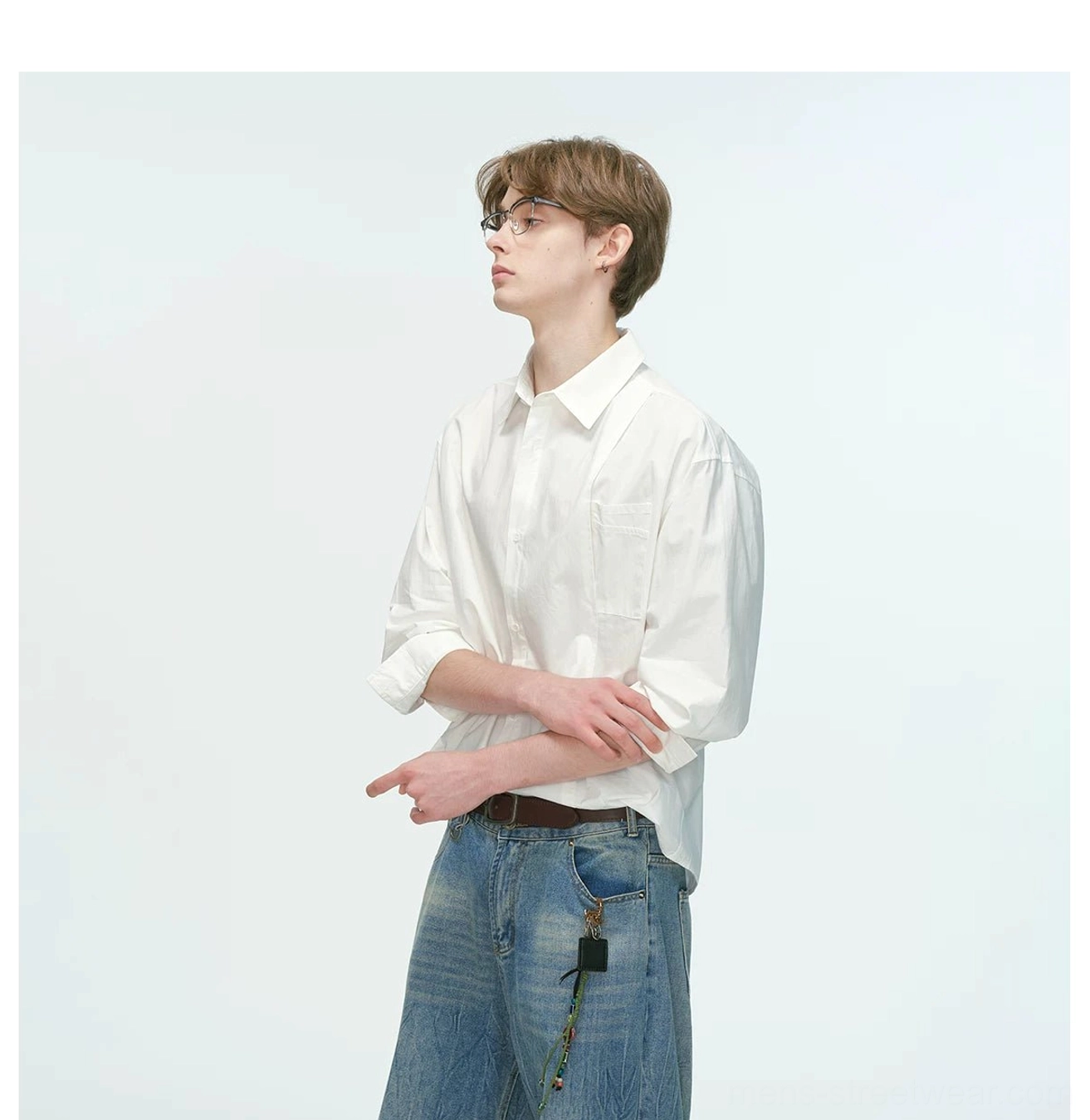 White button-front relaxed poplin shirt with chest pocket styled with blue jeans leather belt and decorative strap