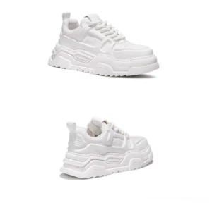 White chunky platform sneakers in front three-quarter view with smooth synthetic upper padded collar and lace-up closure