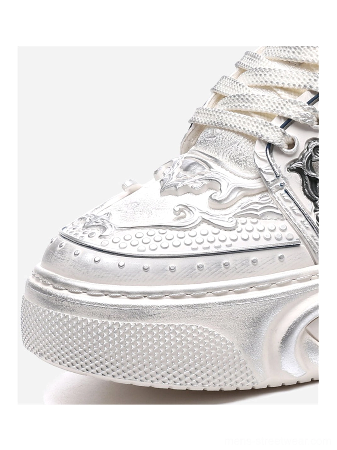 Detailed white chunky platform sneakers with sculpted relief panels, textured mixed upper, and avant-garde streetwear design