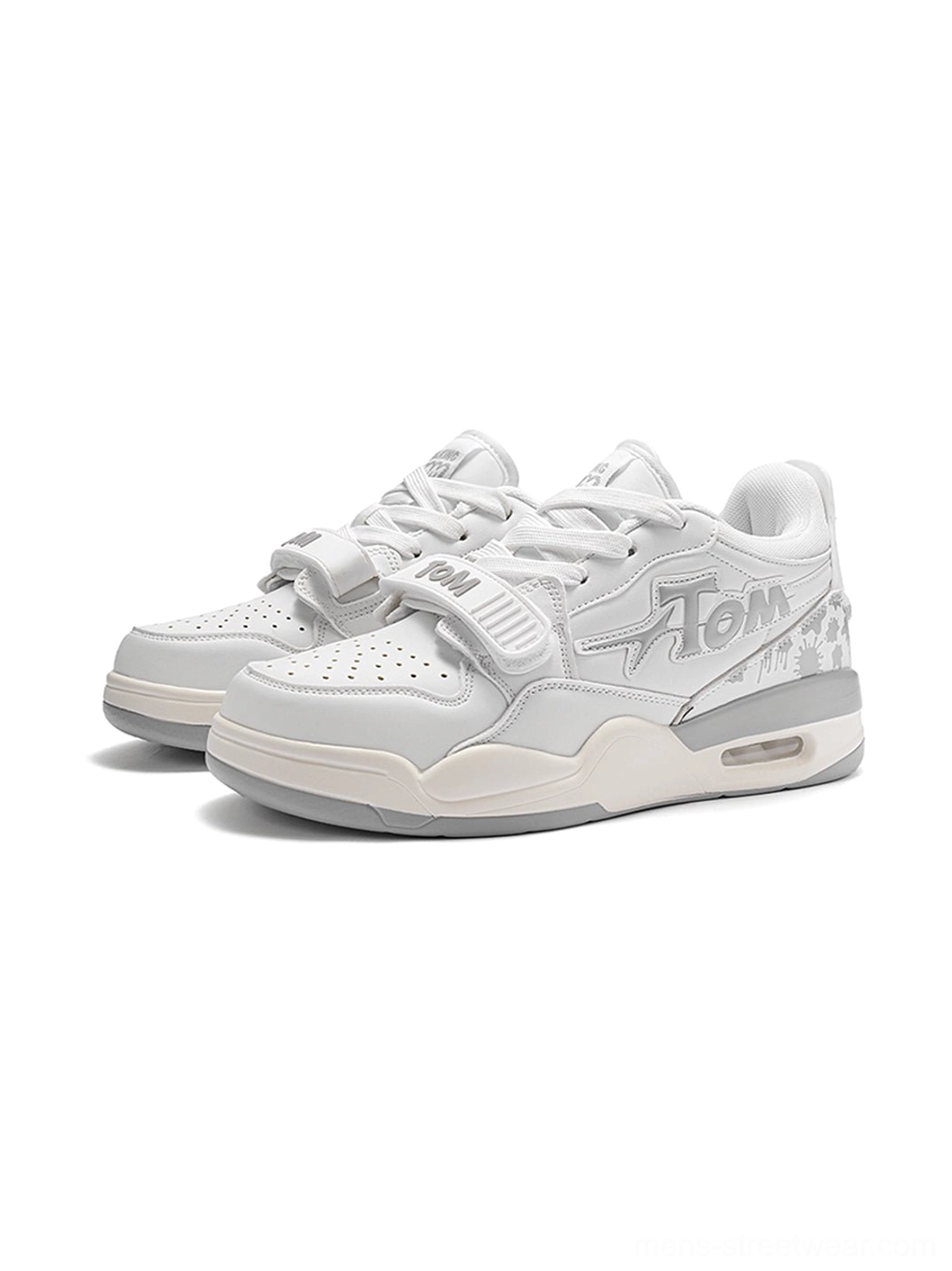 Pair of white colorblock basketball court sneakers shown from a front three-quarter angle with graphic side panels and strap detail