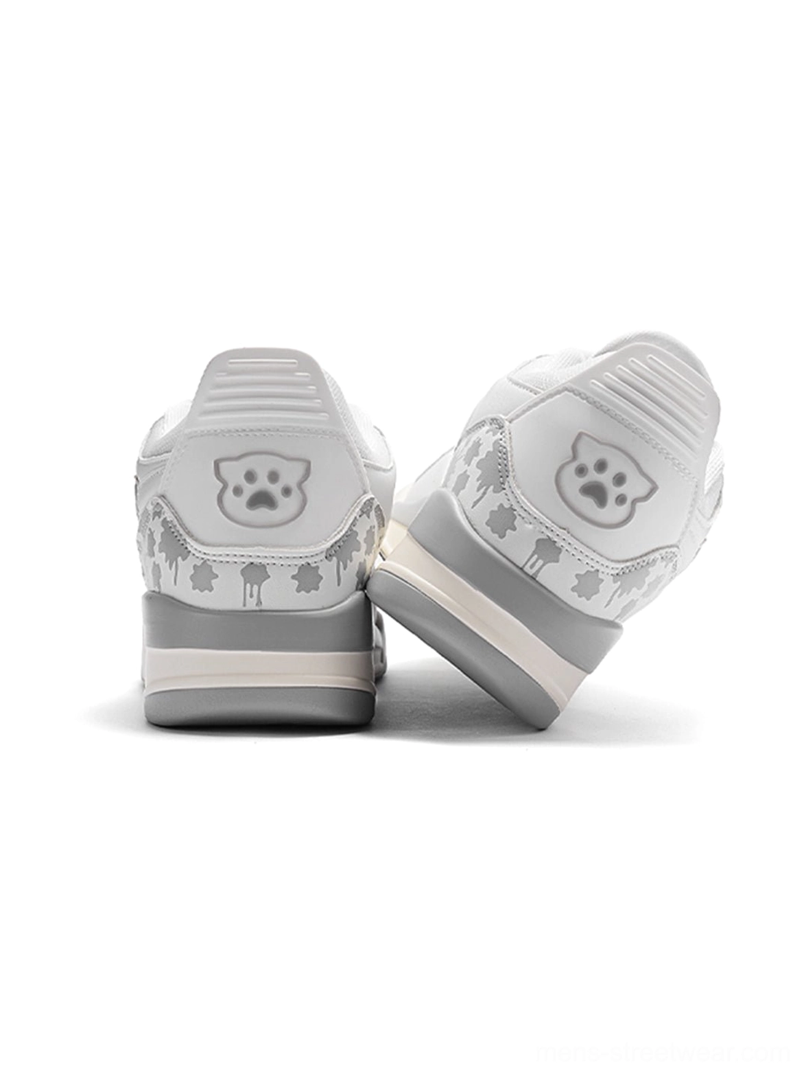 Rear view of white colorblock court sneakers with playful heel artwork, palm-inspired pattern, padded heel caps, and layered sole
