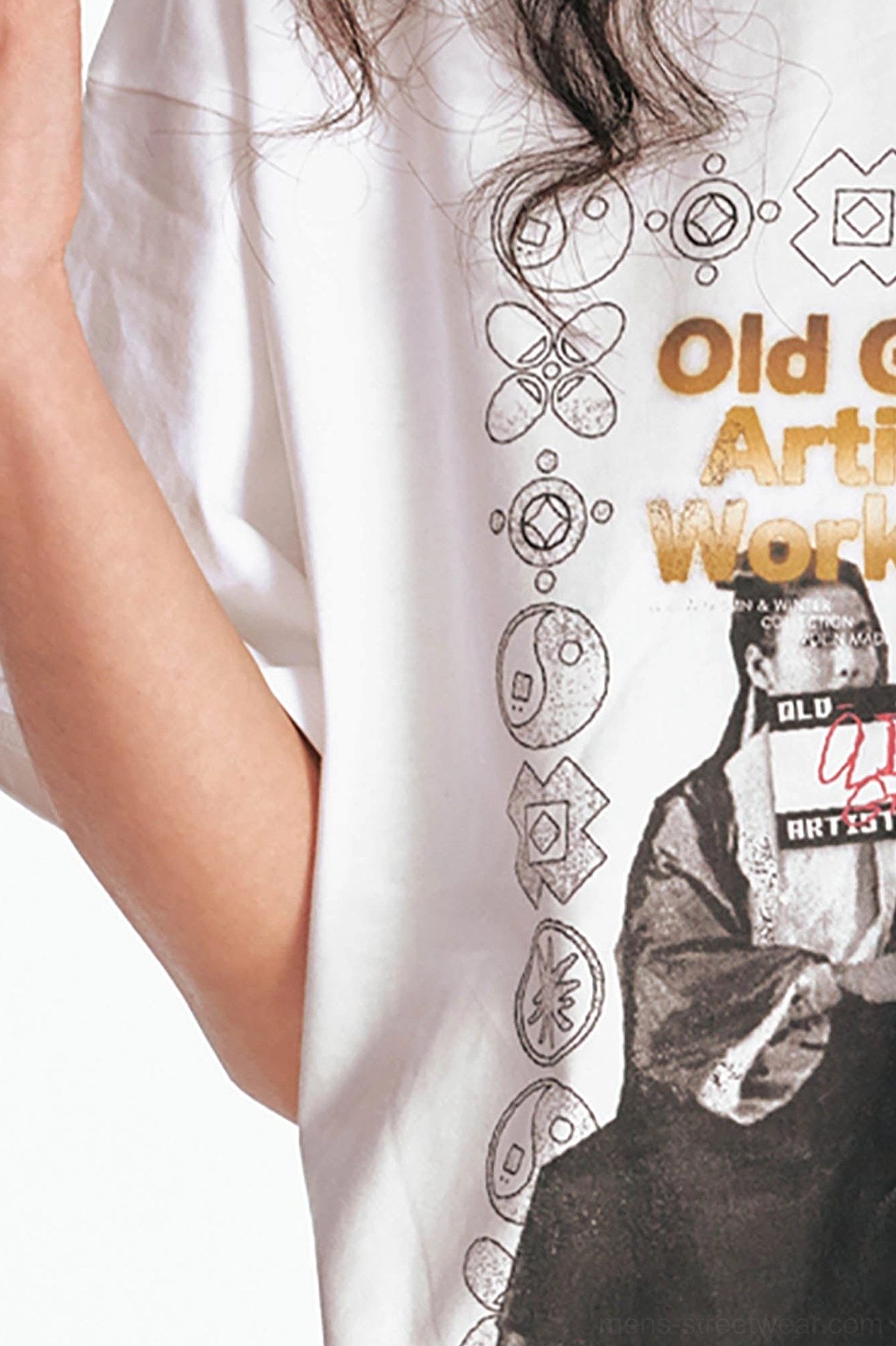 Close-up detail of white cotton cinema poster T-shirt showing golden lettering, monochrome imagery, and decorative vintage borders