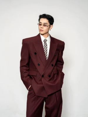 White cotton dress shirt layered under a burgundy double-breasted tailored suit with a striped tie for modern formal menswear styling