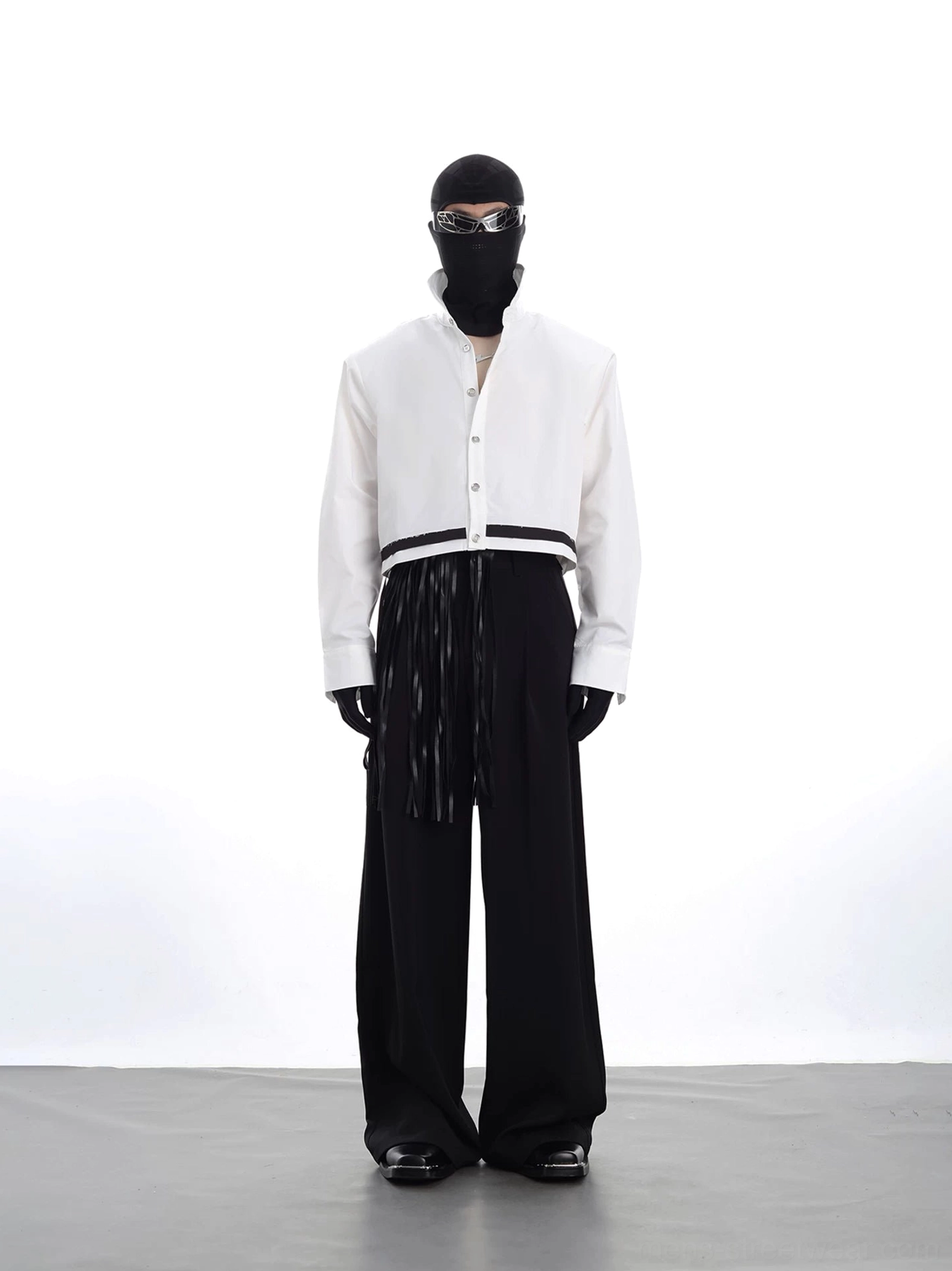 Full outfit styling featuring a white cropped streetwear jacket with black hem trim, wide-leg black trousers, gloves, mask, and futuristic Korean fashion accessories