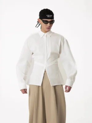 White crosswrap sculpted waist poplin shirt styled with khaki wide-leg trousers, showing the asymmetrical waist wrap, crisp fabric, and modern Seoul streetwear silhouette