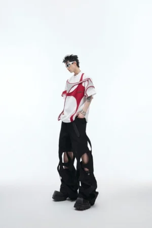 White oversized deconstructed streetwear t-shirt with red and grey layered shoulder details shown from a three quarter front view