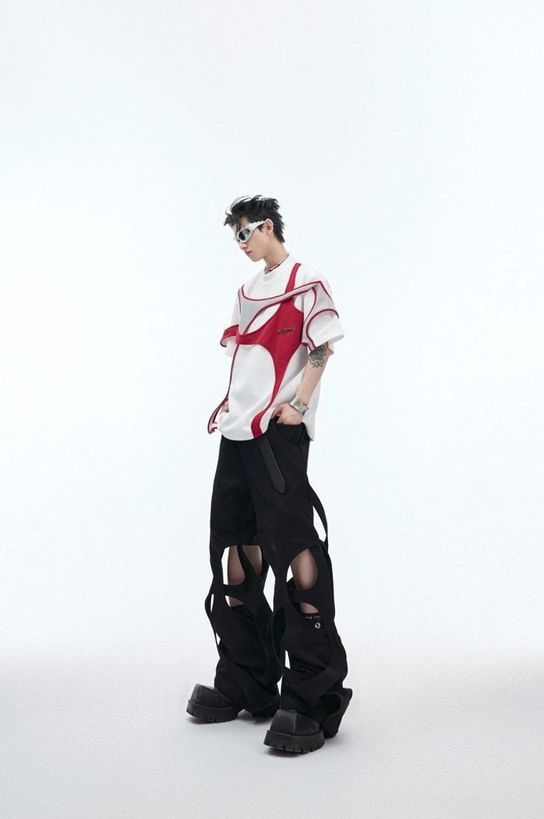 White oversized deconstructed streetwear t-shirt with red and grey layered shoulder details shown from a three quarter front view