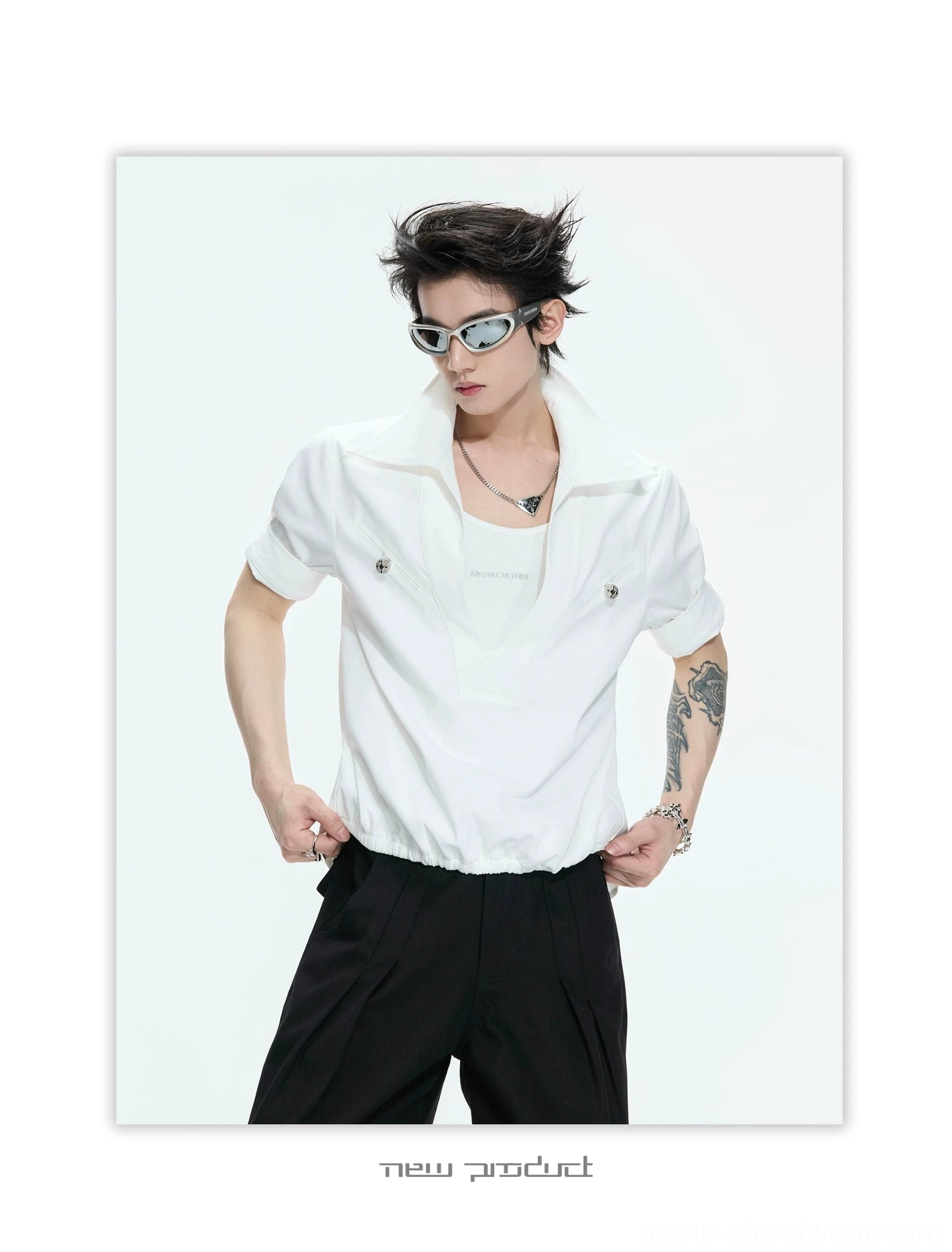 White deep V-neck utility shirt with metallic chest pocket details, rolled short sleeves, gathered hem, black tailored pants, and minimalist Korean fashion styling