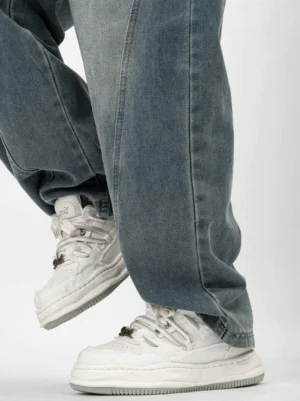 White distressed chunky platform sneakers shown from the rear on foot with dissolved-style thick sole and padded low-top collar
