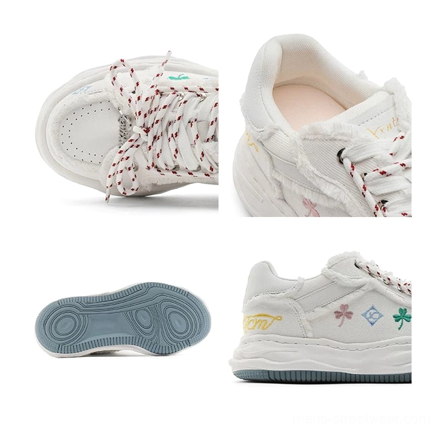 White distressed embroidered platform sneakers showing toe heel outsole side profile frayed panels and chunky rope laces