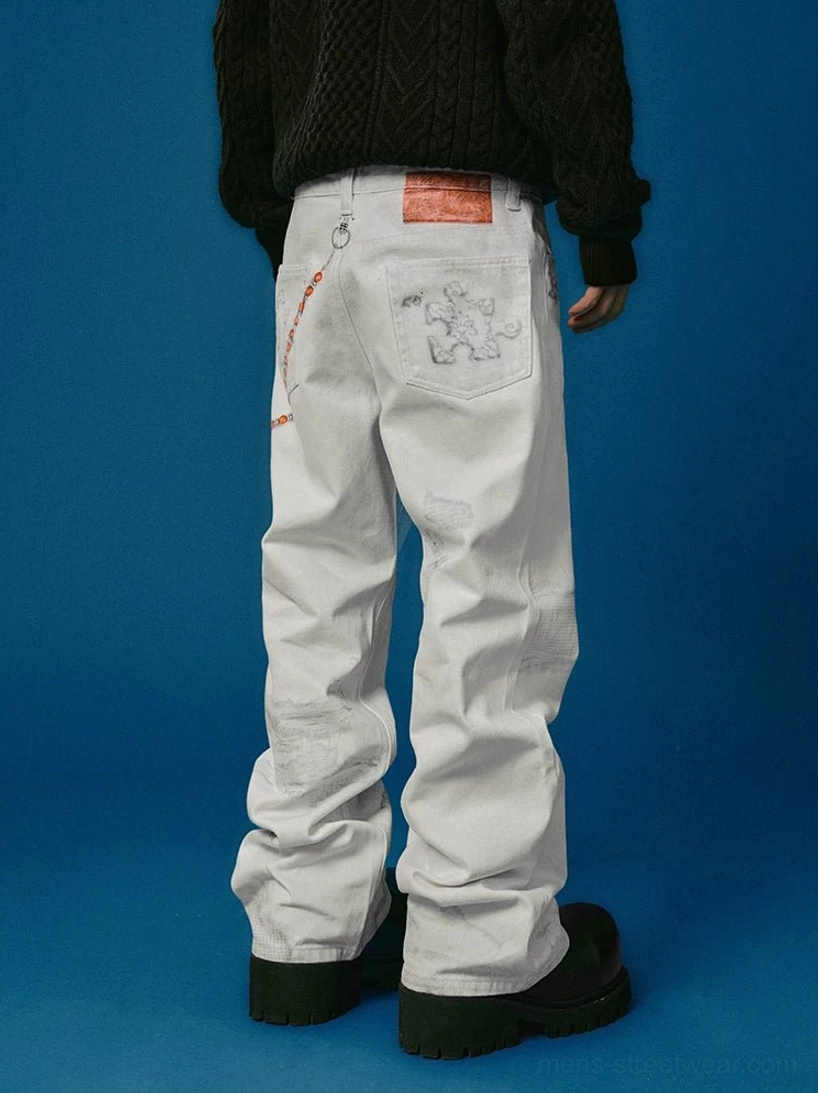 Full back view of white distressed wide-leg jeans with rear pocket details, decorative chain, faded wash, and black platform shoes