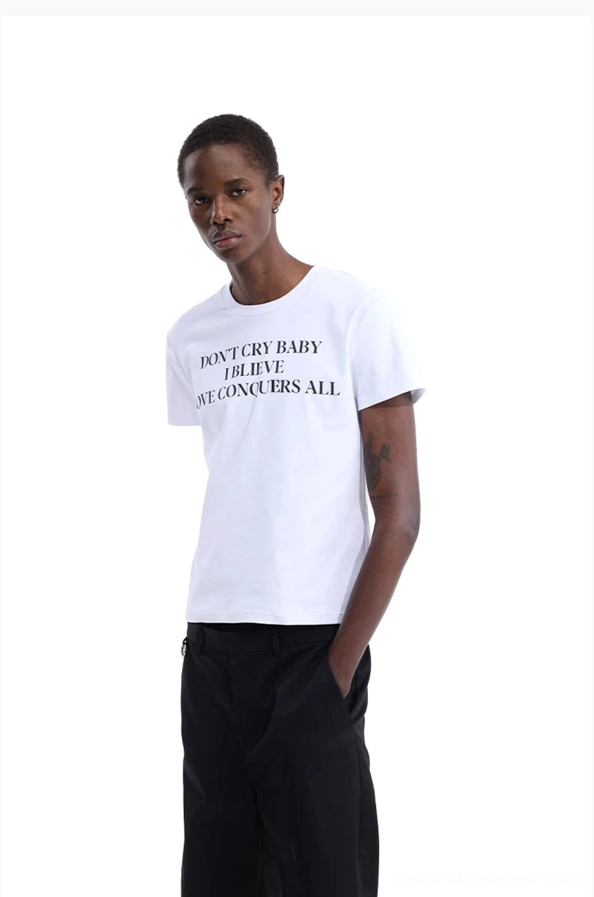 White Don’t Cry Baby graphic T-shirt with black serif slogan styled with black wide-leg pants