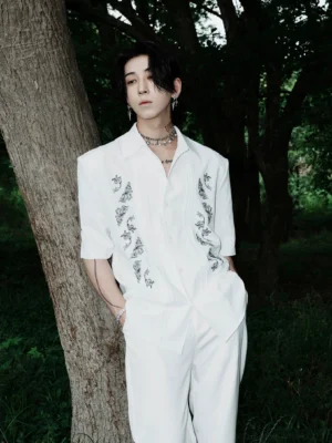 White dragon embroidered Cuban shirt with relaxed fit styled with white wide-leg pants in an outdoor Korean streetwear look