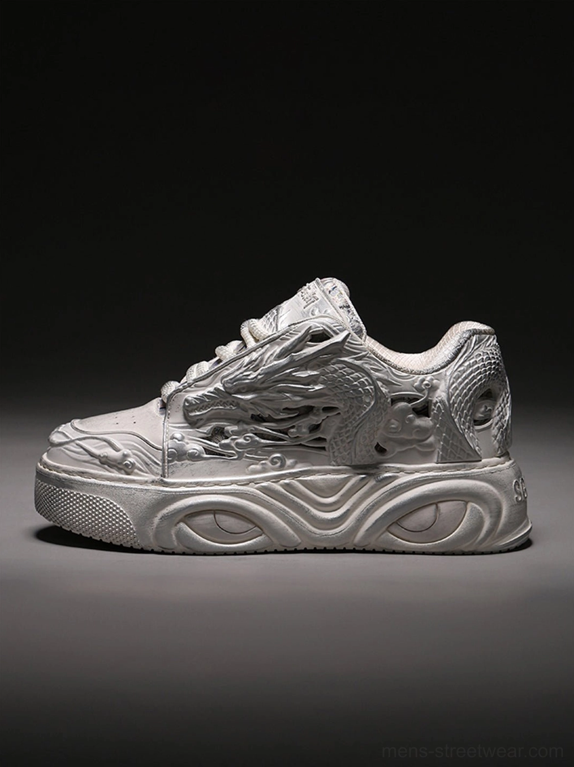 Single white dragon relief platform sneaker shown from the right side with a detailed raised dragon pattern and thick streamlined sole