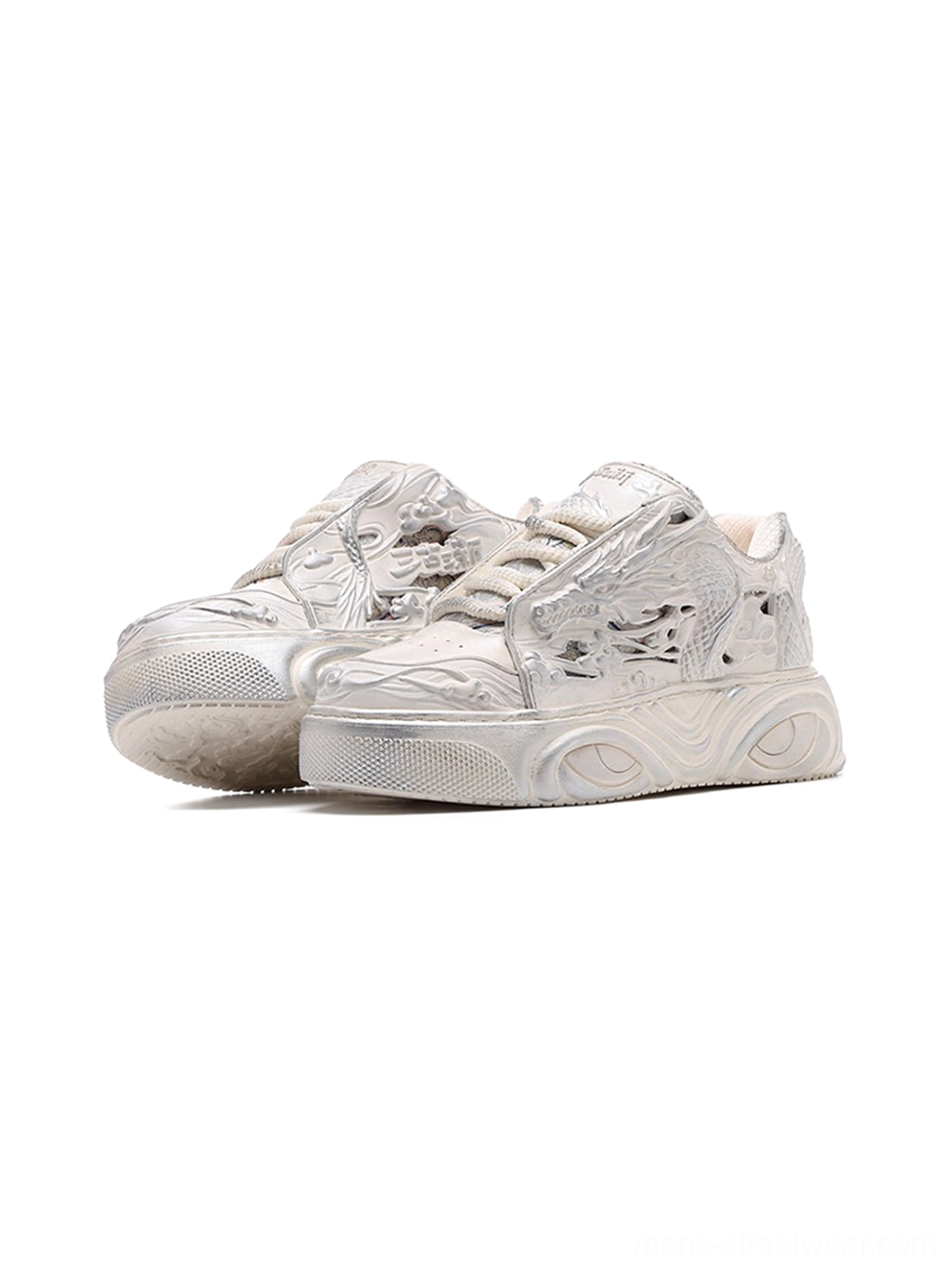 Front view of white and silver-toned dragon relief platform sneakers with low-top lace-up styling and chunky soles