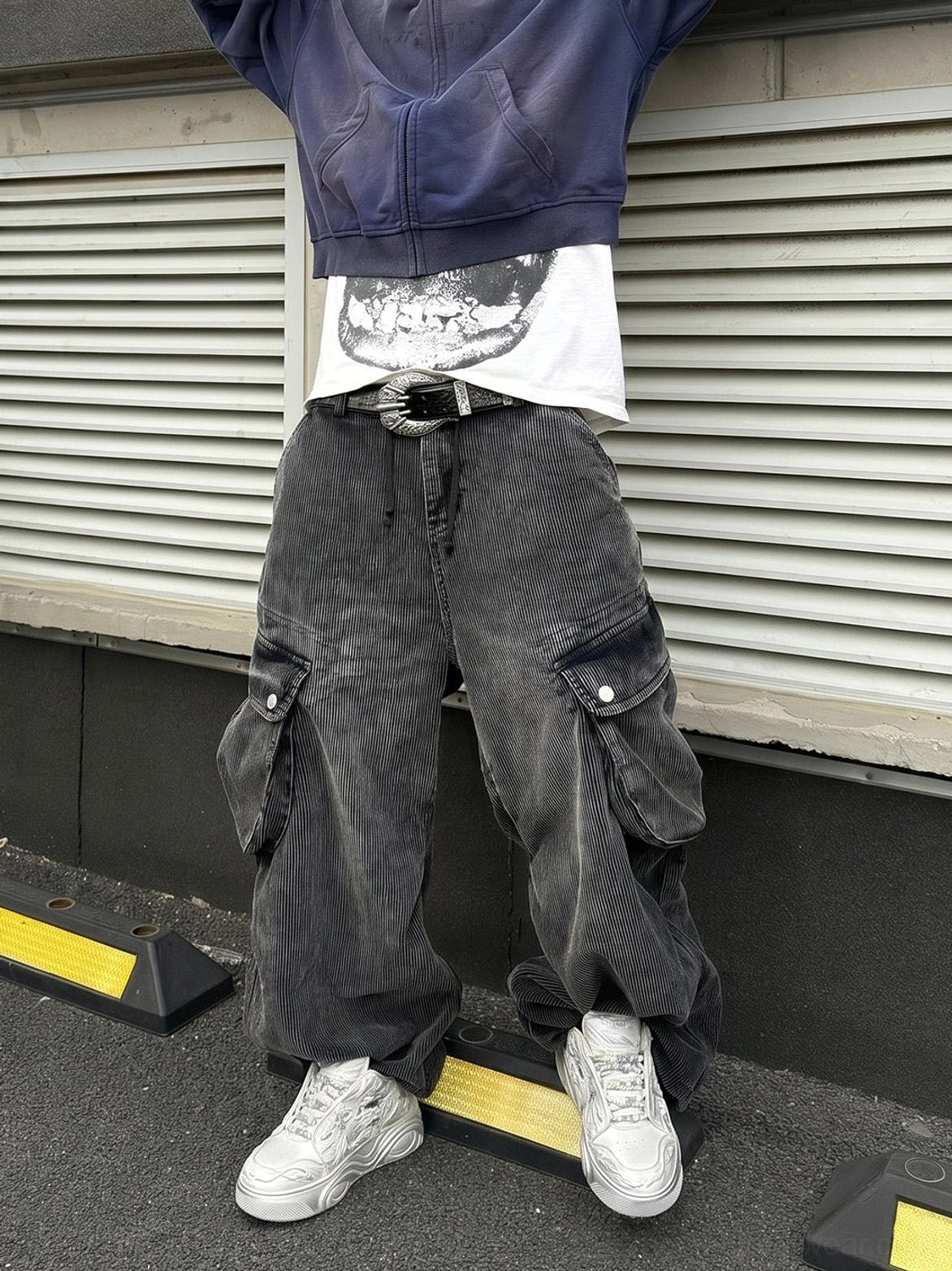 White dragon relief platform sneakers worn with washed cargo jeans and a cropped hoodie in an urban streetwear outfit