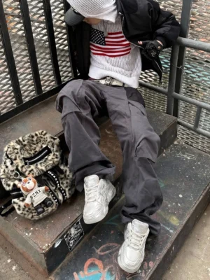 White dragon relief platform sneakers styled with loose cargo pants in an industrial Seoul-inspired streetwear stairwell