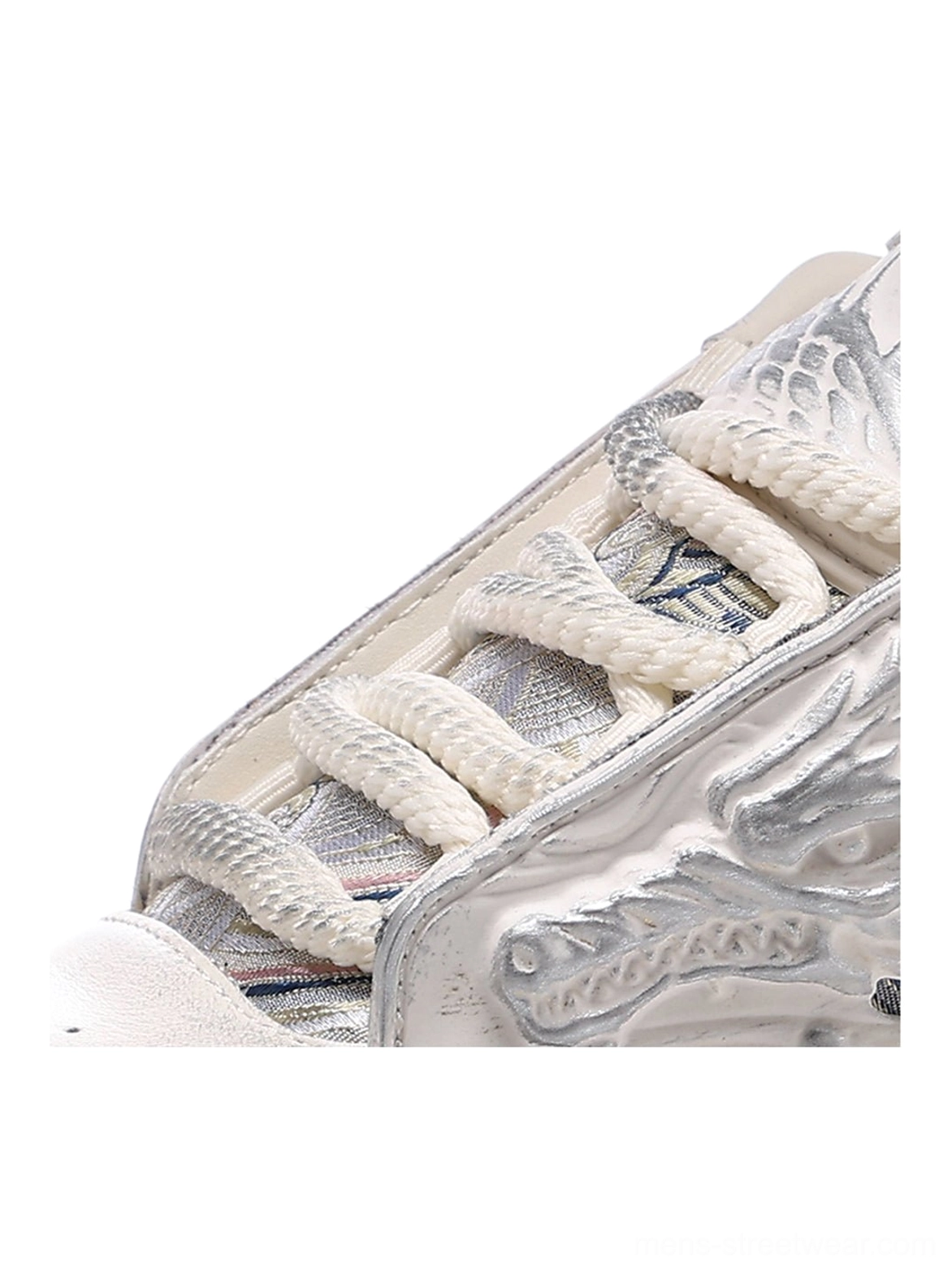 White dragon relief platform sneakers detailed product view with tonal embossed dragon panels and an oversized wavy sole