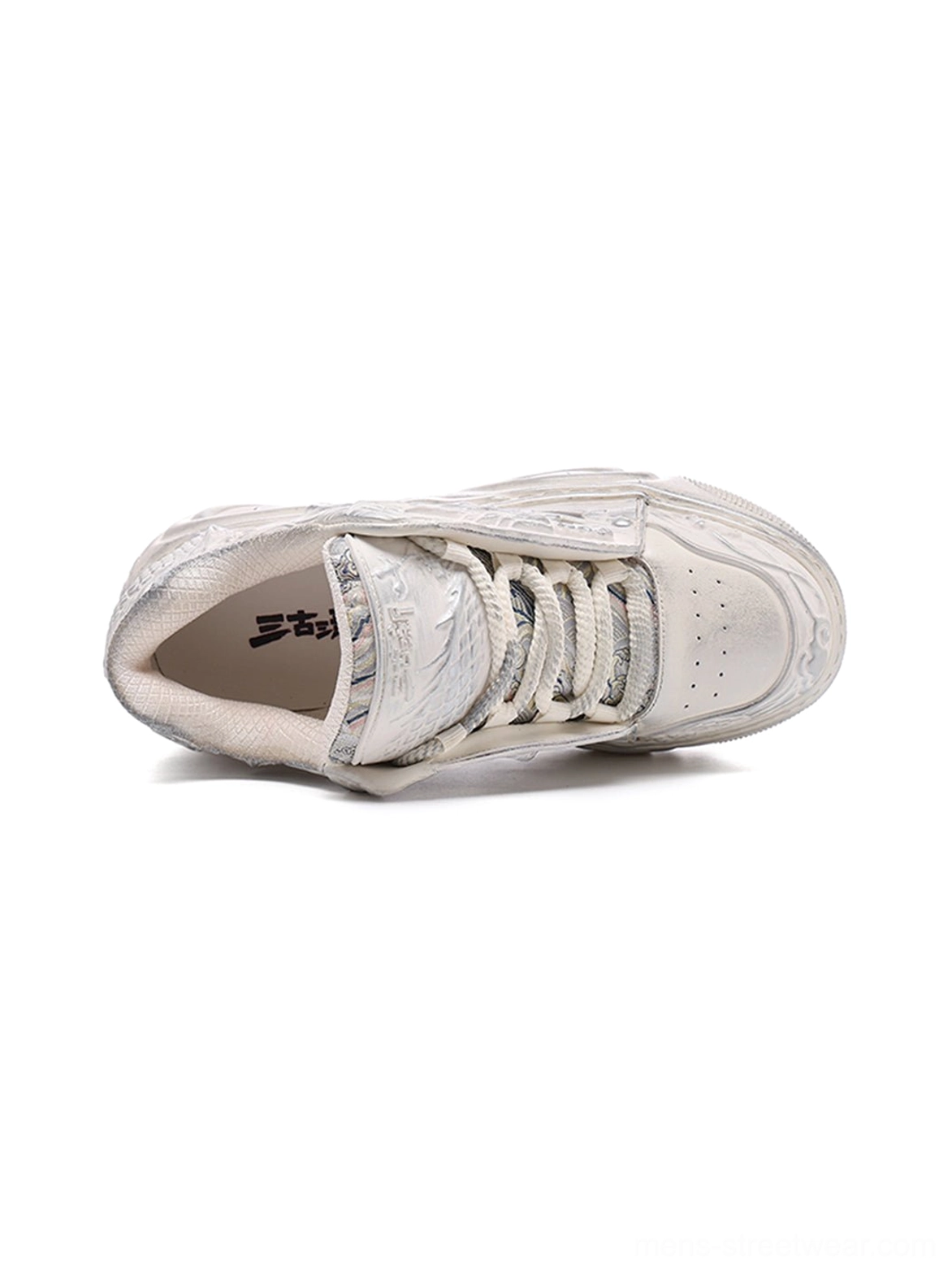 Top view of a white dragon relief platform sneaker showing the lace-up closure, textured upper, and detailed inner footbed