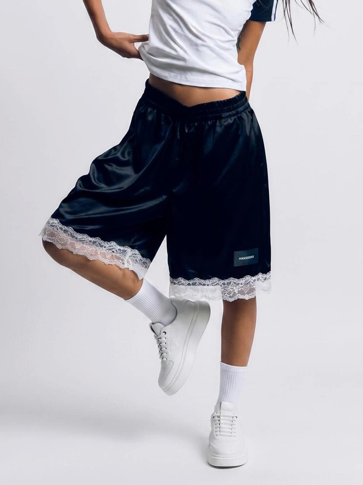 White chunky platform sneakers with tonal embossed texture worn in a contemporary Seoul streetwear outfit