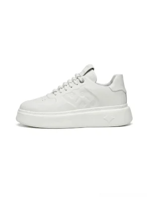 White embossed monogram chunky platform streetwear sneakers side profile close-up on a clean white studio background