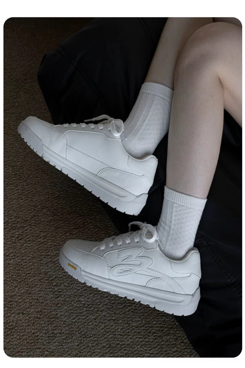 White flame detail platform skate sneakers worn with white crew socks in an everyday streetwear outfit top view