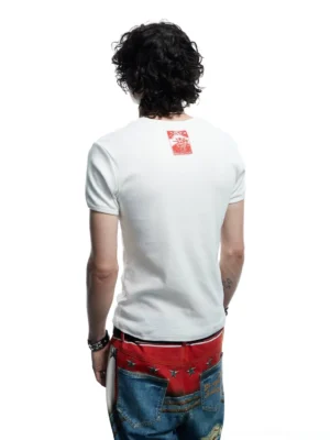 Back view of white slim-fit flaming skull baby tee showing clean rear panel and red printed tag detail with streetwear denim styling