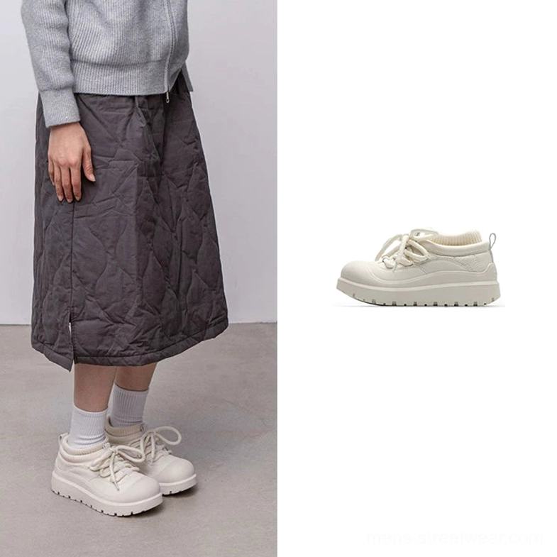 White fleece-lined platform sneakers for winter streetwear with chunky lugged outsole, secure laces, and contemporary urban silhouette