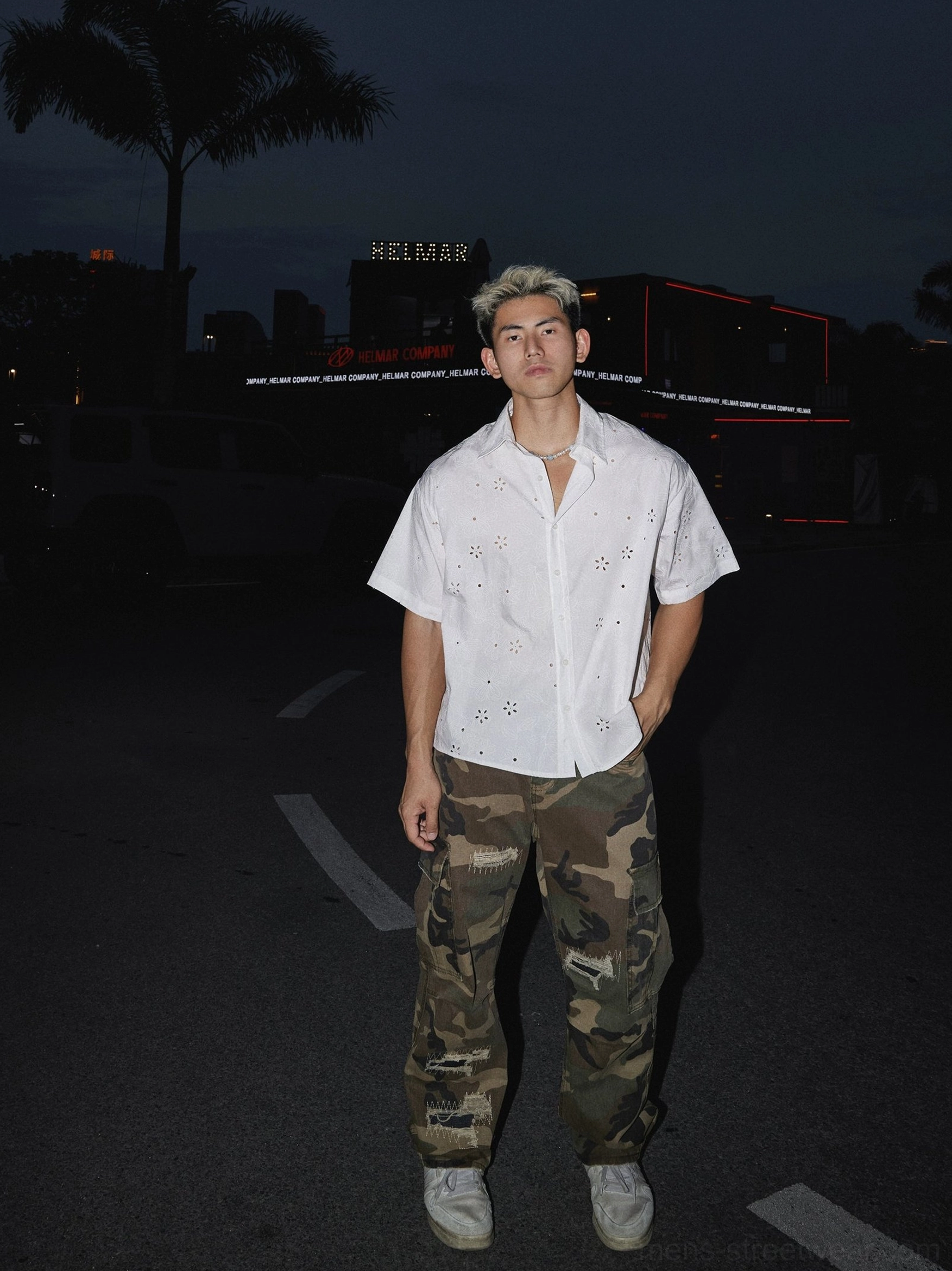 White floral eyelet oversized short sleeve shirt styled with camouflage cargo pants and casual sneakers