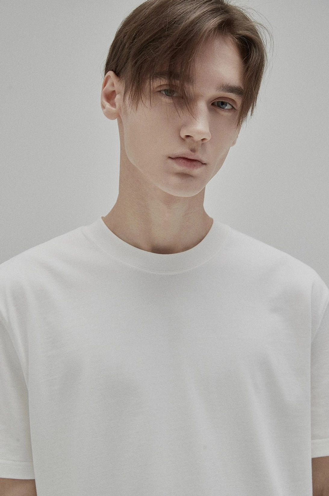 Close-up front view of white GIZA cotton crew neck T-shirt showing the clean collar and smooth cotton fabric texture