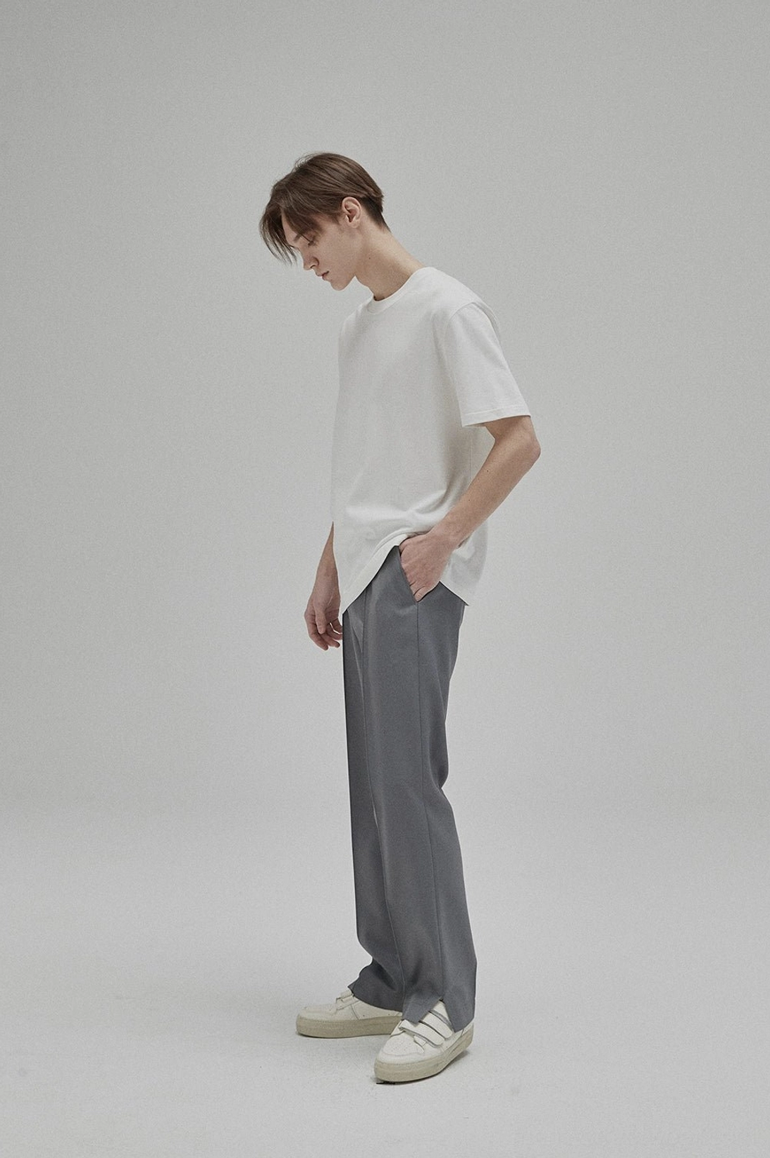 Side view of a white GIZA cotton crew neck T-shirt showing its clean drape and relaxed everyday silhouette