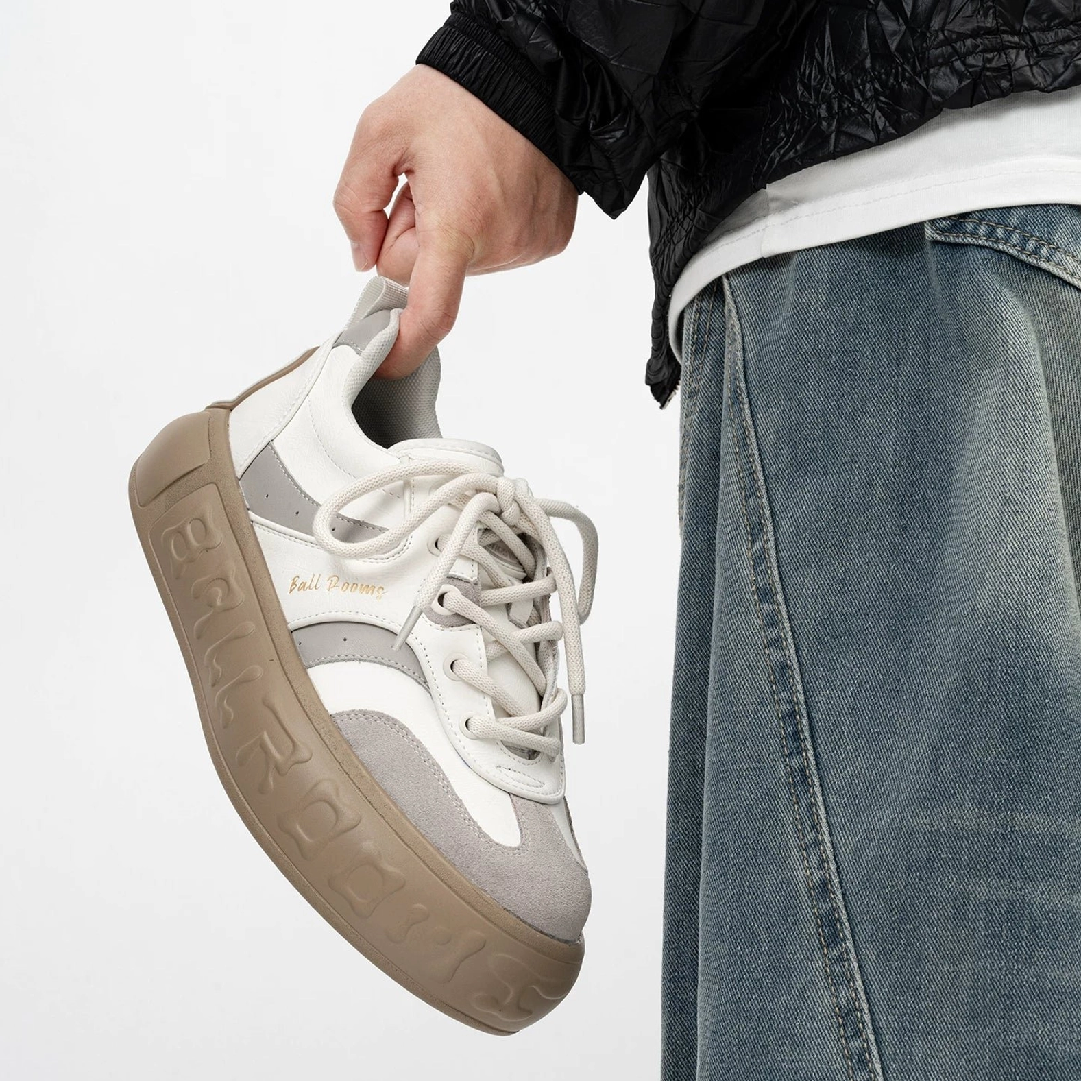 White gray and brown color block chunky sneakers with suede toe panel lace up closure and embossed gum outsole styled with layered streetwear