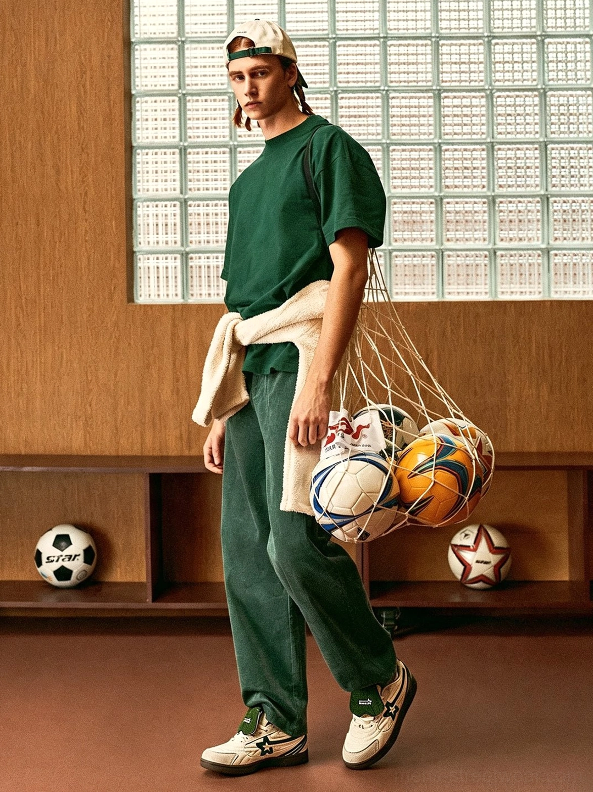 Full retro sport outfit styled with white green detachable tongue sneakers and a mesh bag filled with sports balls