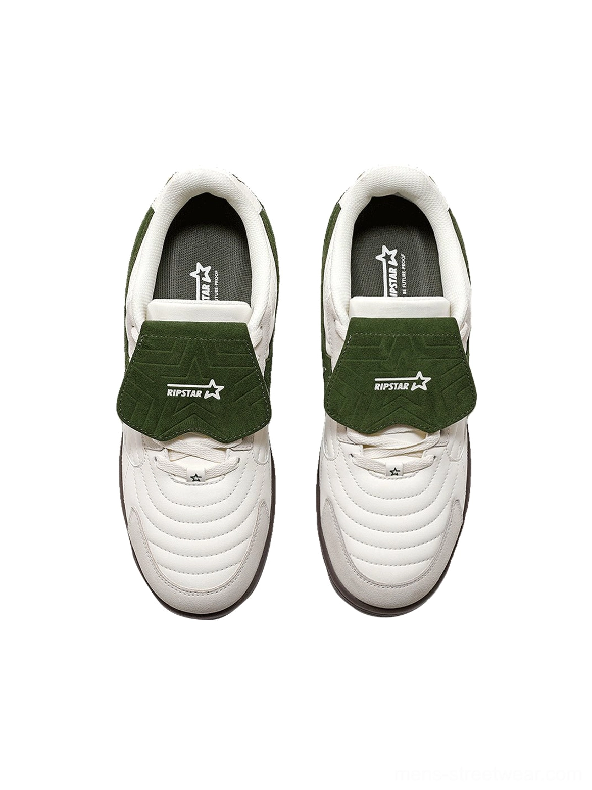 Top view of paired white green streetwear sneakers showing the quilted toe caps green detachable tongues and star insoles
