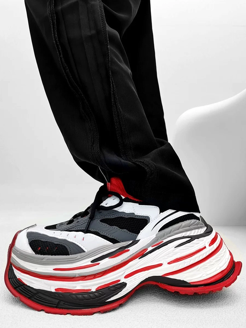 White grey and red chunky platform running sneakers with color-blocked mesh upper and layered red-trimmed sole