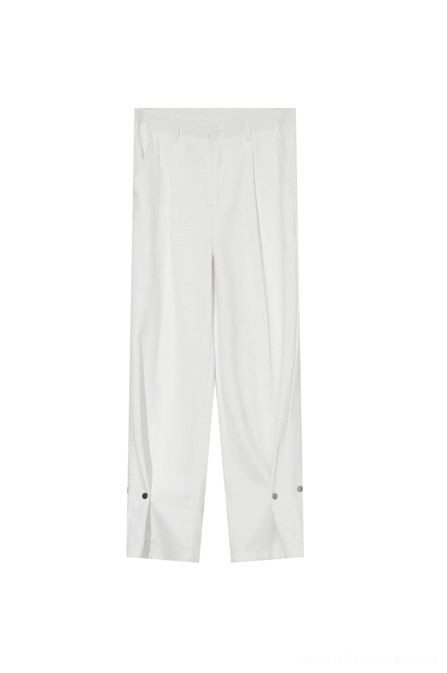 Flat lay view of white high-waisted loose straight trousers with tailored waistband, front pleats, and side snap cuff details