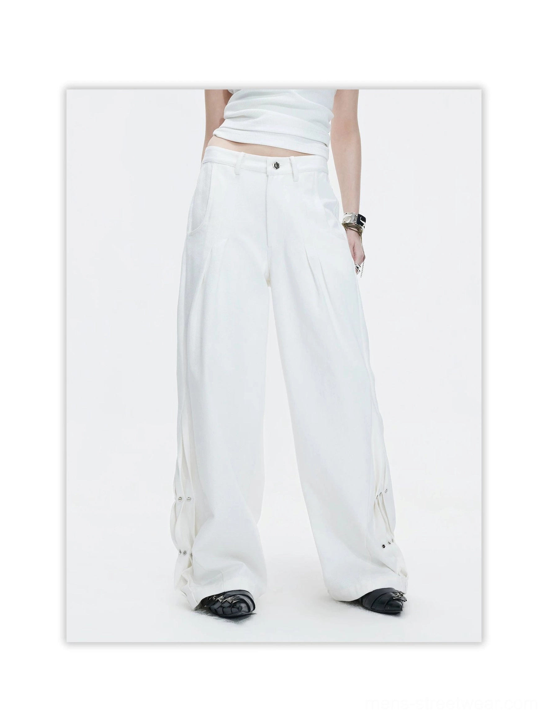 White high-waisted wide leg pants front view with front pleats, extra-wide silhouette, and metal snap hem details