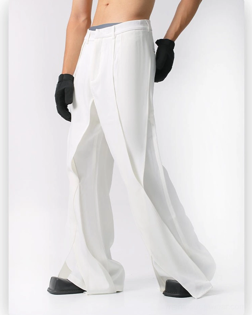 White high-waisted wide-leg flared suit trousers with front pressed pleats, hidden waist closure, matte fabric, and ankle side slits