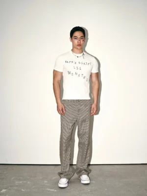 White Korean-style fitted graphic tee modeled with high-waisted checked trousers and white casual sneakers in a full-body studio look