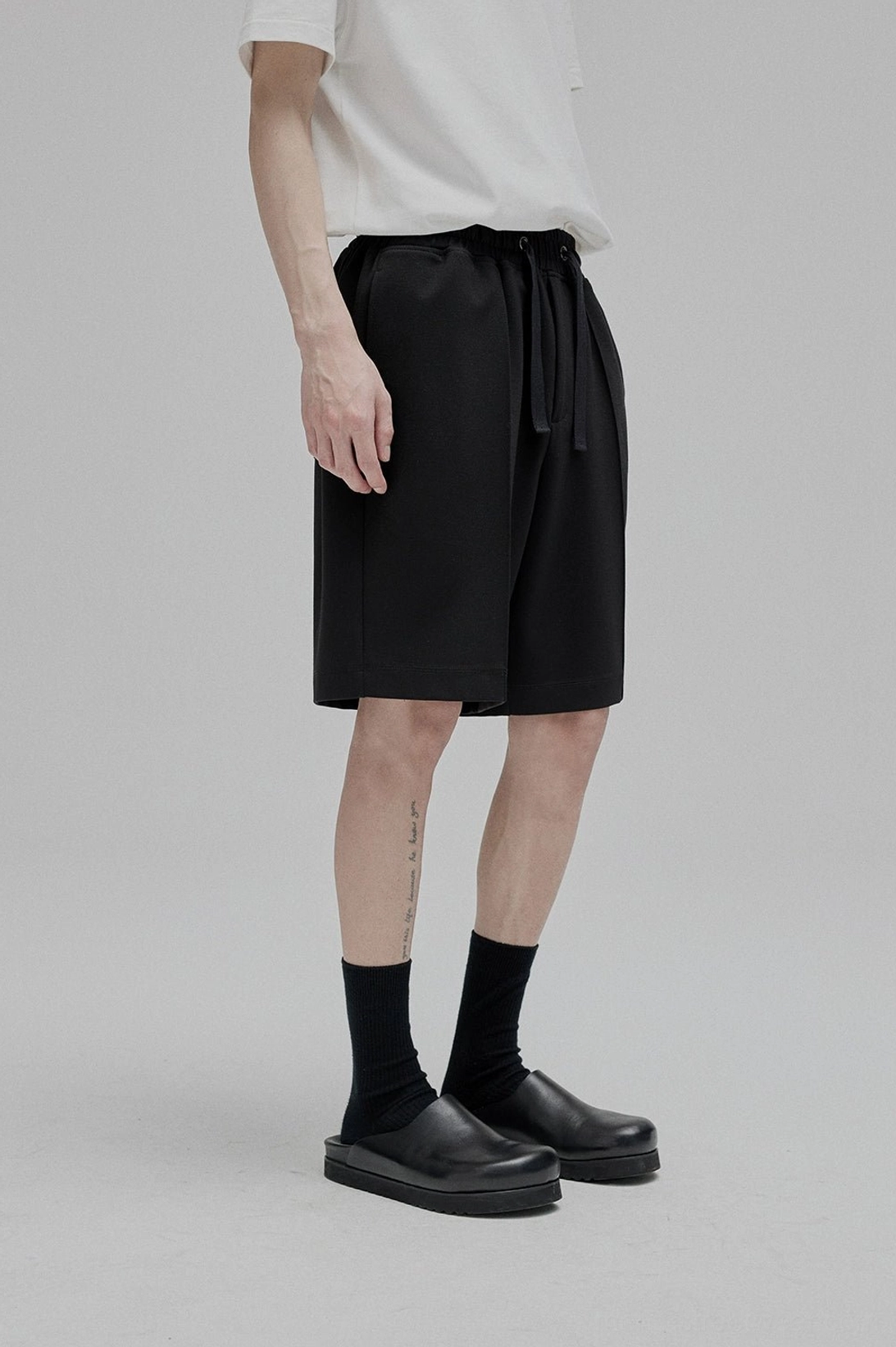 White lace-up straight leg shorts leg opening tapered ankle proportion silhouette detail